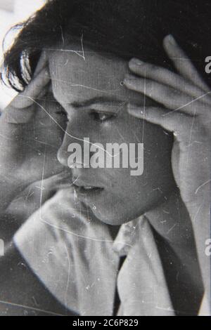 Fine 70s vintage black and white lifestyle photography of a teenager in deep thought. Stock Photo
