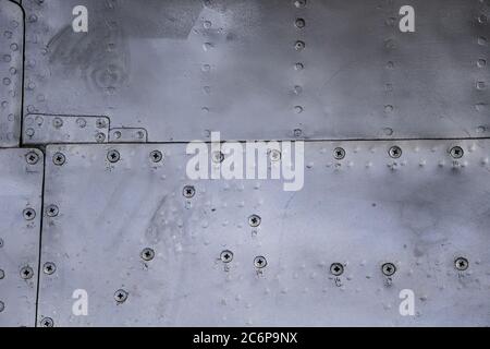 Aircraft skin close up. Rivets on gray metal. Aluminum texture Stock Photo