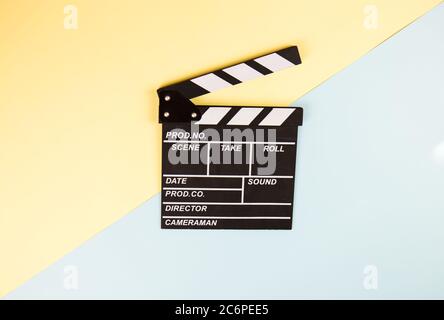 Cinema clapperboard on yellow blue colorful background - Movie cinema entertainment concept Stock Photo