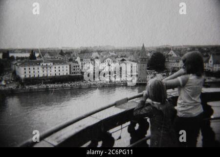 Fine 70s vintage black and white lifestyle photography of young tourists admiring the scenic town. Stock Photo