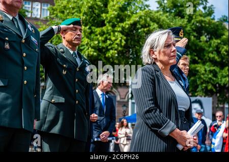 Minister of Defense Ank Bijleveld attends the ceremony.The National Memorial Srebrenica-Genocide is held every year on July 11 at Het Plein in The Hague since 1997. On this day, more than eight thousand victims of the genocide in Srebrenica are commemorated. Due to the Coronavirus situation, few people were allowed to stay at the square, the ceremony could be also followed via live stream. Former Minister Jan Pronk, and Minister of Defense Ank Bijleveld both gave a speech, and the names of the victims were read followed by a two minute moment of silence. This year the square was surrounded wit Stock Photo