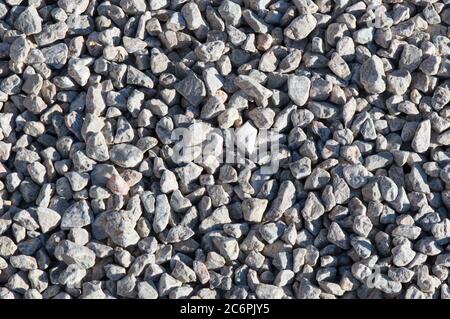 Small stones texture background; pile of light grey pebbles; decorative pathway Stock Photo