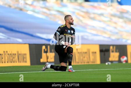 Manchester City's Kyle Walker takes a knee in support of the Black Live Matter movement during the Premier League match at the Amex Stadium, Brighton. Stock Photo