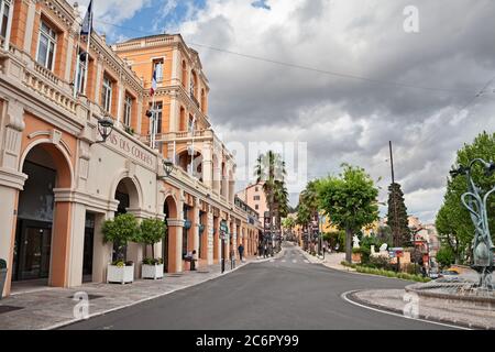 Grasse, Provence-Alpes-Cote d’Azur, France: cityscape of the city center with the Congress Palace and the street lined with palm trees. Photo taken on Stock Photo