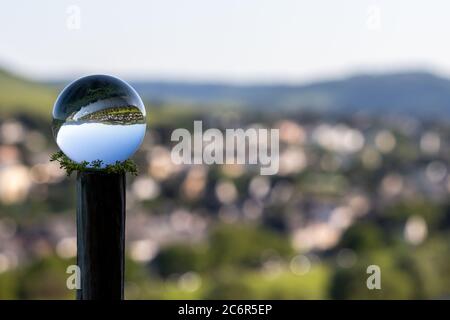 Crystal ball with lriver Moselle valley and defocused background Stock Photo