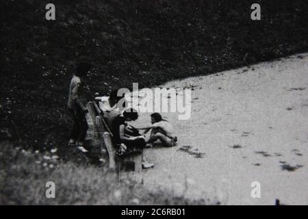 Fine 70s vintage black and white lifestyle street photography of a family hanging out at the waterfront. Stock Photo