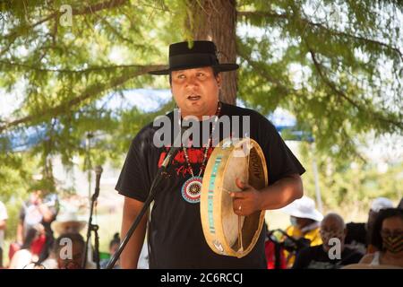 Oklahoma City, OK, USA. 11th July, 2020. An indigenous performer plays a drum at the Society to Protect Indigenous Rights and Indigenous Treaties' Sit-In for Indigenous Resistance where protesters were there to peacefully protest the monument on July 11, 2020. Credit: Leslie Spurlock/ZUMA Wire/Alamy Live News Stock Photo