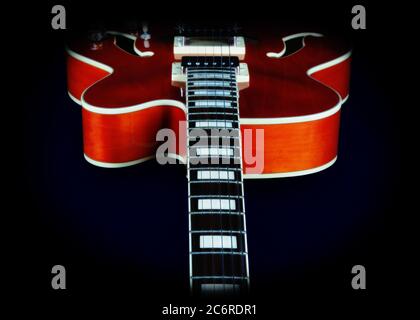 Detail of an Ibanez AF75 Hollowbody Electric Guitar in transparent orange showing a view from the neck. This photo has a painting effect added. Stock Photo