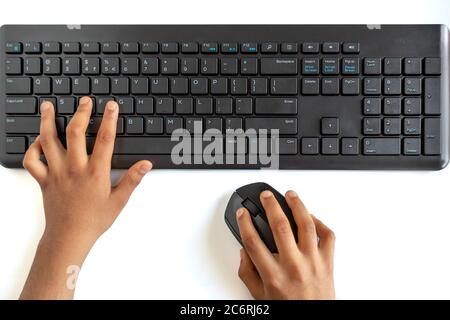 Black Wireless Keyboard and Mouse Isolated on white background. Peron tying and holding mouse in hand. Stock Photo