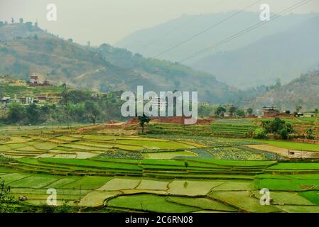 Agricultural farming fields in Nepal, seen from a road connecting Pokhara and Kathmandu. Stock Photo