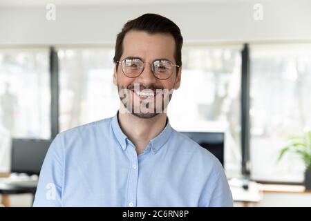 Headshot portrait of smiling Caucasian businessman pose in office Stock Photo