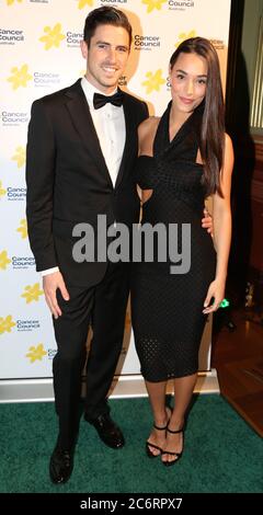 Scott Tweedie and Georgia Berg arrive on the green carpet (red carpet) for the Emeralds & Ivy Ball 2014 to raise money for Cancer Council Australia. Stock Photo