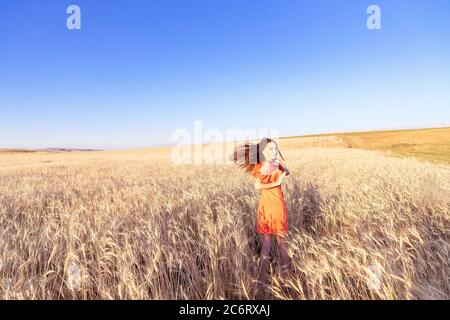 Pretty young woman running wheat field.  Stock Photo