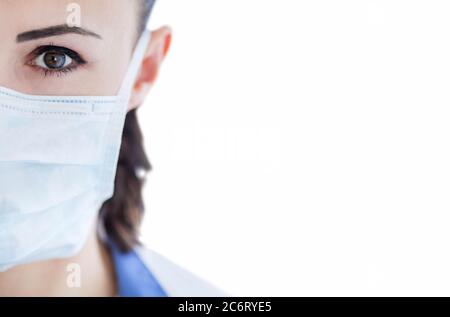 Female doctor or nurse in medical mask holding syringe with injection Stock Photo