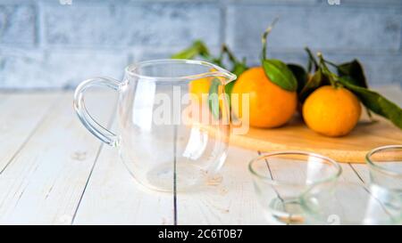 A glass teapot with the small cups on the table. Stock Photo