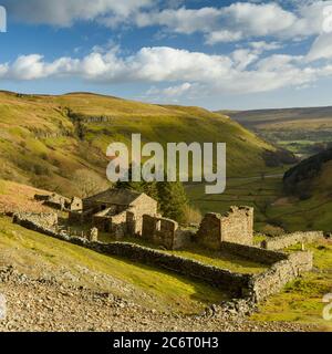 Crackpot Hall (old farmhouse ruins) high on remote sunlit hillside overlooking scenic rural Yorkshire Dales hills & valley (Swaledale) - England, UK.