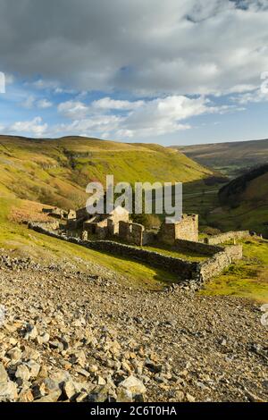 Crackpot Hall (old farmhouse ruins) high on remote sunlit hillside overlooking scenic rural Yorkshire Dales hills & valley (Swaledale) - England, UK.