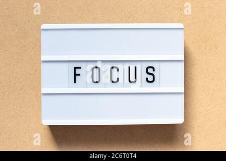 White lightbox with word focus on wood background Stock Photo