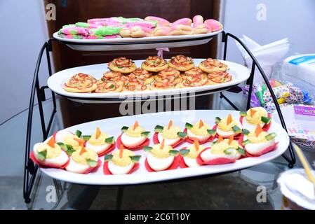 Egg boats, mini pizza and mini éclairs at a kid’s birthday party. Stock Photo