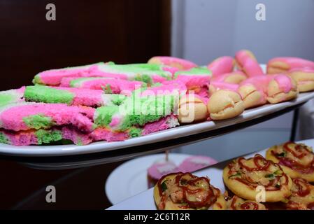 Mini pizza, mini éclairs and mini sandwiches at a kid’s birthday party. Stock Photo