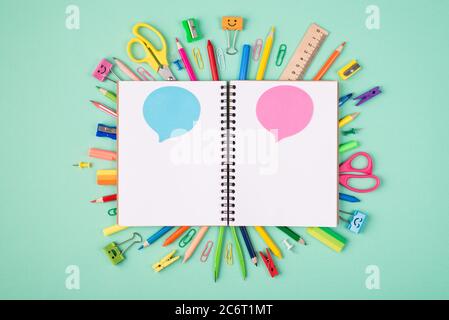 Express ideas and thoughts concept. Top above overhead view photo of colorful stationery and blank notebook with blue and pink bubbles isolated on tur Stock Photo