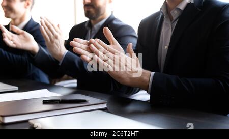 Close up group of businessmen in formal suit clapping hands. Stock Photo