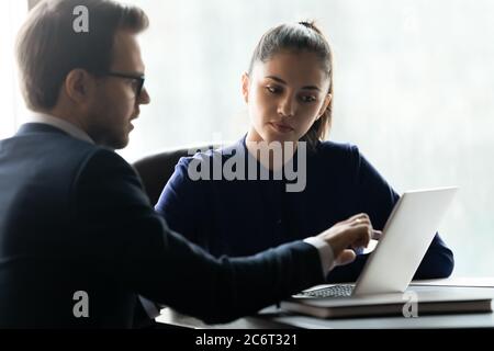 Two business people discussing online project details. Stock Photo