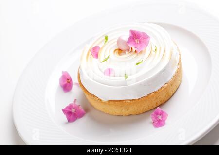 Gourmet lemon pie with  meringue and edible flowers Stock Photo