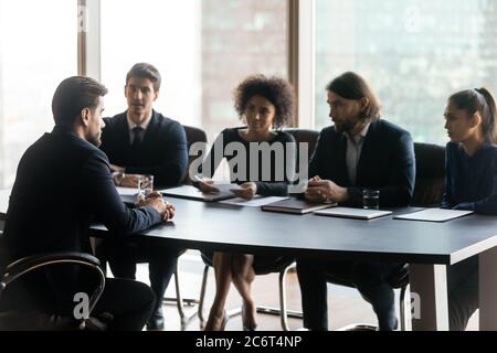 Young mixed race hr managers interviewing job candidate. Stock Photo
