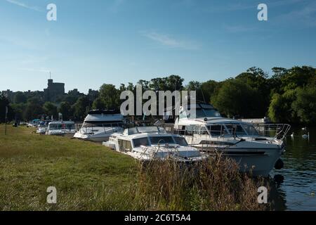 Windsor, Berkshire, UK. 12th July, 2020. River lovers are back spending their weekends on their pleasure cruisers on the River Thames following the easing in the Coronavirus lockdown rules. Credit: Maureen McLean/Alamy Live News Stock Photo