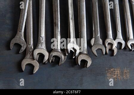 Close up a lot of Wrench on old wooden board background. Stock Photo