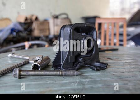 New rubber engine mount with tools on the table background. Stock Photo