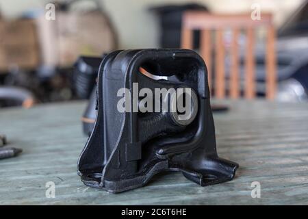 New rubber engine mount with tools on the table background. Stock Photo