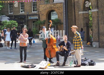London, UK. 11th July, 2020. A jazz band plays in the open air in Chelsea as UK government approves live performances in the open air. Credit: Brian Minkoff /Alamy Live News Stock Photo