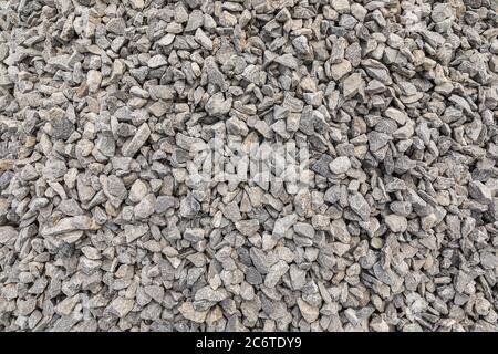 Grey crushed pebbles, background image. Crushed stone texture Stock Photo