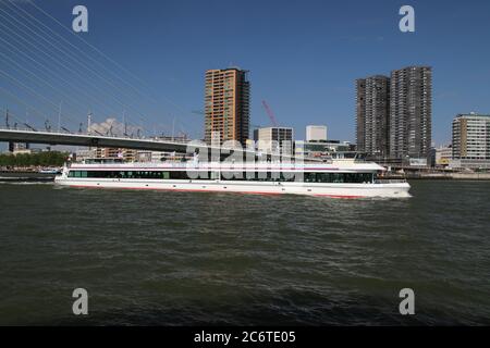 Spido tour boat sails under the Erasmus Bridge on the Nieuwe Maas in Rotterdam Stock Photo