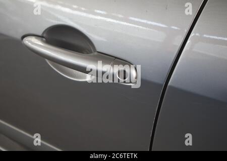 Lock detail of the driver's door lock of a modern car in silver gray color Stock Photo