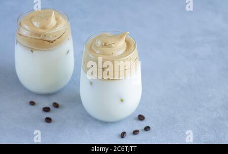 Cold Dalgon Coffee with ice and milk in glasses. Trendy whipped Korean cuisine coffee drink Stock Photo