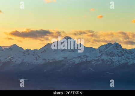 Mountain Triglav sunset clouds Slovenia Alps highest snow white winter Stock Photo