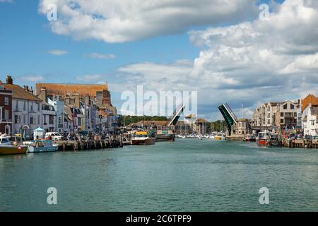 Weymouth harbour with the town bridge open to allow boats access, Weymouth, England, UK Stock Photo