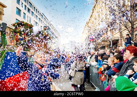 STUTTGART, BADEN-WÜRTTEMBERG / GERMANY - MARCH 4, 2014: Happy woman throwing confetti during the traditional carnival on Shrove Tuesday. Stock Photo