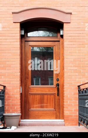 Wooden vintage entry door decorated with arch. New York. USA. Stock Photo
