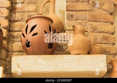 clay jars on a stone shelf in orient room. close up Stock Photo