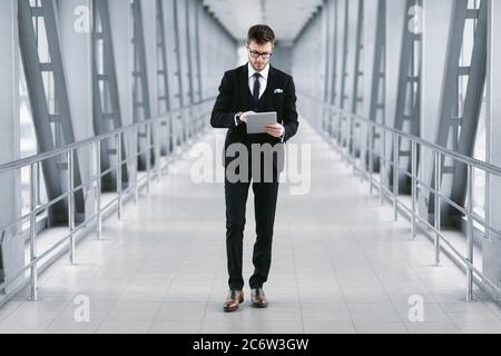Focused urban business man holding digital tablet Stock Photo