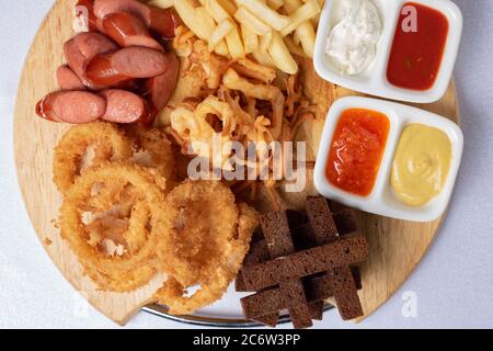 Beer snacks. Sauces, chips, potato, crispy bread . Top view Stock Photo