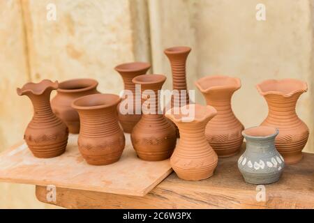 different clay pots on a wooden table Stock Photo