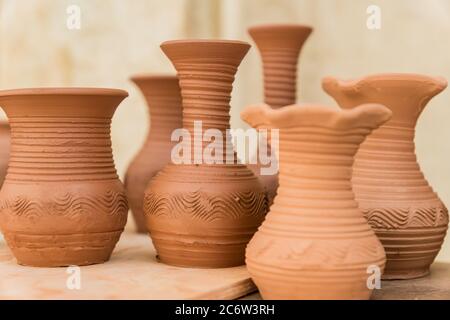 different clay pots on a wooden table Stock Photo