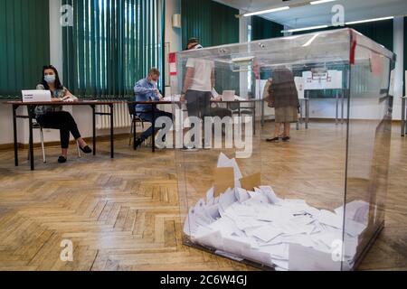 Warsaw, Poland. 12th July, 2020. The electoral commission and the ballot box seen at the polling station during elections.12th July marks the second round of the presidential elections, where the Poles will choose between the Mayor of Warsaw Rafal Trzaskowski and Andrzej Duda, who is seeking re-election. Credit: SOPA Images Limited/Alamy Live News Stock Photo