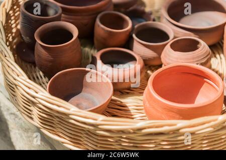 clay pottery in wicker basket close up Stock Photo