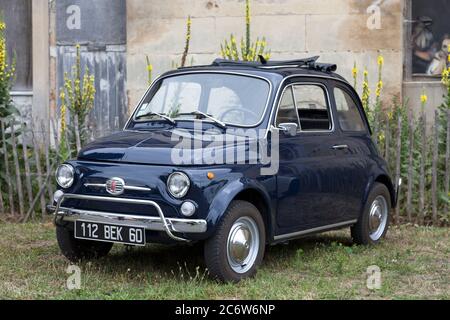 Lamorlaye, France - July 05 2020: The Fiat 500 is a small city car that was manufactured and marketed by Fiat Automobiles from 1957 to 1975. Stock Photo